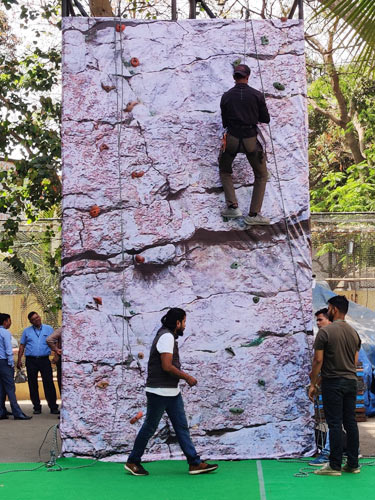 Man is climbing on artificial rock wall